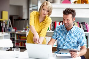 Man and woman working on laptop